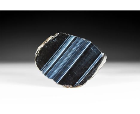 A section of tiger'eye in black and Blue, cut and polished to show the iridescent structure.  318 grams, 90mm (3 1/2"). From 