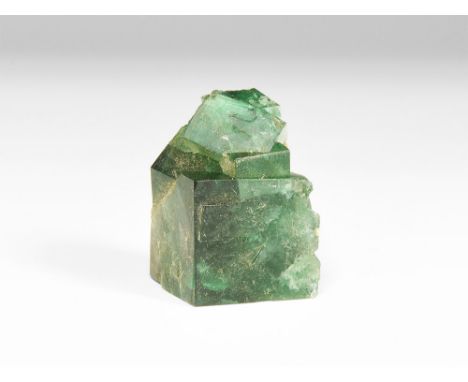A fine specimen of a deep green fluorite; in old white card tray with old Gregory, Bottley & Lloyd label reading: Green Fluor