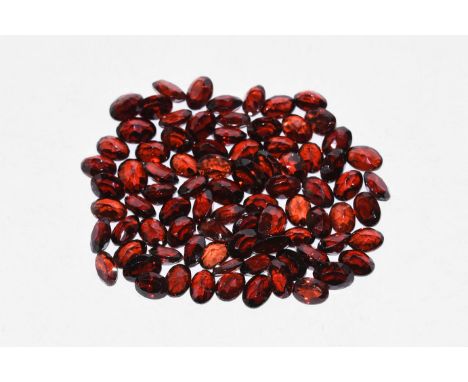 A group of eighty three mainly oval-cut garnets of a deep red colour, approximately 90 carats in total.  18 grams total, appr