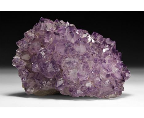 A fine specimen of deep purple amethyst crystals formation, in white card tray with label reading, from Rio Grande do Sul, Br