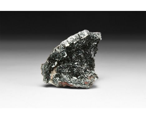 A fine specimen of specularite (specular hematite) in white card tray with label reading: 'Specularite, Florence Mine, Cumbri