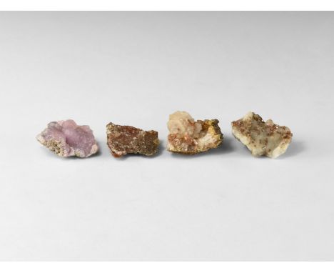 A group of four mineral specimens comprising of: two examples of adamite, one of vandianite and one of smithsonite; each in c
