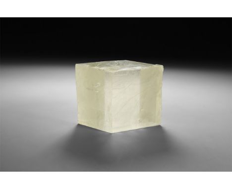 A finely cut large specimen of a pale yellow spar, in white card tray with a label reading: 'Iceland Spar, Nuevo Leon, Mexico