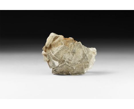 A fine specimen of transparent fluorite cubes formation with hematite flakes, in white card tray with label reading: 'Fluorit