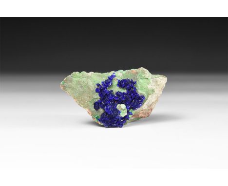 A fine specimen of deep blue azurite on matrix, in a white card box with label reading: 'Azurite, Morenci Mine, Arizona, USA'