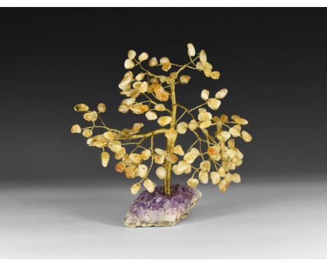 A medium size gemstone tree consisting of a brass trunk and branches tipped with polished citrines, mounted on a section of a