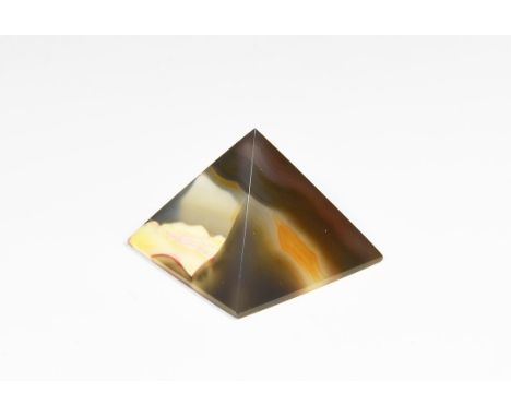 A finely cut and polished white, brown, pink and creme agate pyramid, in white card tray, possibly colour enhanced.  41 grams