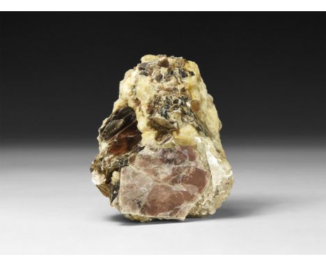 A fine specimen of quartz matrix with accessory brown muscovite, in white card tray with label reading: 'Muscovite in Quartz,