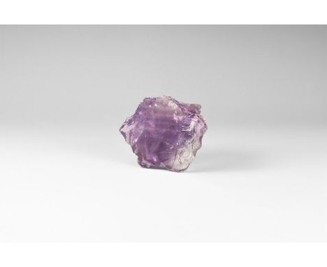 A fine deep purple amethyst specimen cut and polished to one side, with rainbow reflections; in white card tray with label re