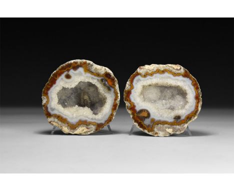 A pair of finely cut and polished mini geodes of banded agate and pale blue quartz crystals to the centre.  400 grams total, 