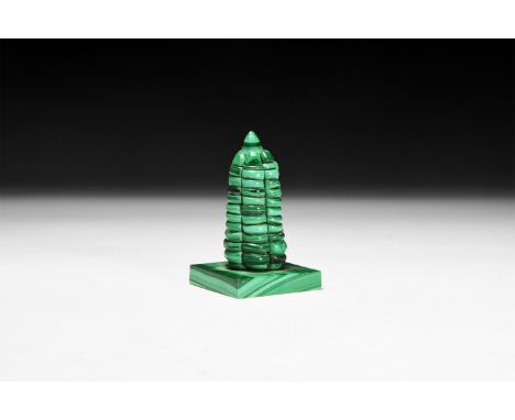 A finely composed statuette of a 'tower' on a rectangular base from banded green malachite.  100 grams, 70mm (2 3/4"). From a