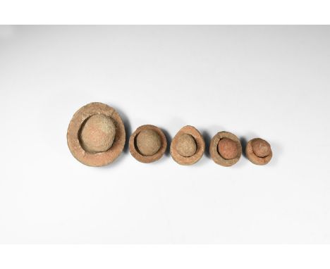 Group of five wind-rounded pebbles with their individual hollowed out 'nests', from the Kalahari Desert region, western Afric