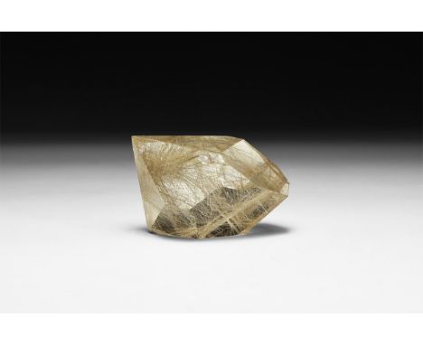 A fine specimen of quartz with numerous golden rutile needles, in white card tray with label reading: 'Rutilated quartz freef