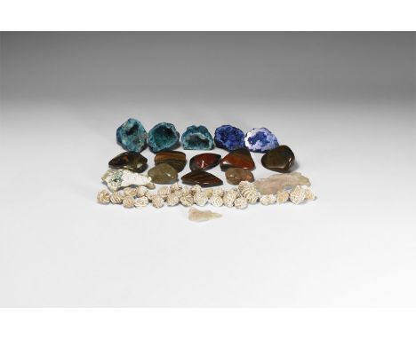 A mixed group comprising: a group of selenite rose specimens from Mexico; a group of rutile crystals in polished quartz from 