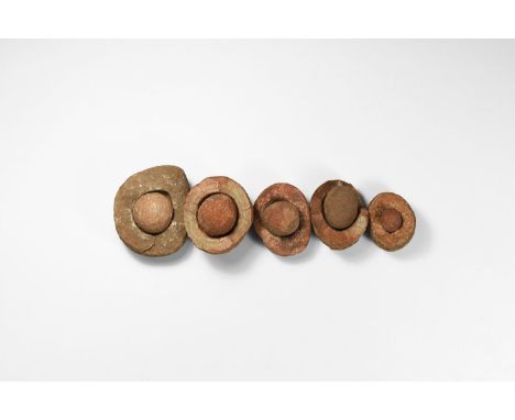 Group of five wind-rounded pebbles with their individual hollowed out 'nests', from the Kalahari Desert region, western Afric