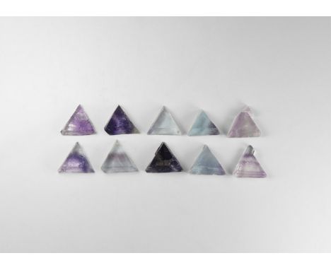 A group of ten fluorite cleavage triangles ranging in colour from pale blue to dark purple. See Bonewitz, Dr. Ronald Louis, R
