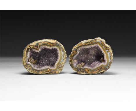 A pair of finely cut and polished mini geodes of banded agate and liliac amethyst crystals to the centre.  242 grams total, 6
