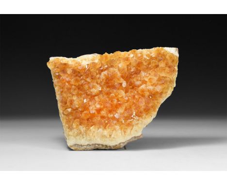 A substantial section of a natural geode with richly coloured citrines to the inner face.  1.3 kg, 17cm (6 3/4"). From a hist