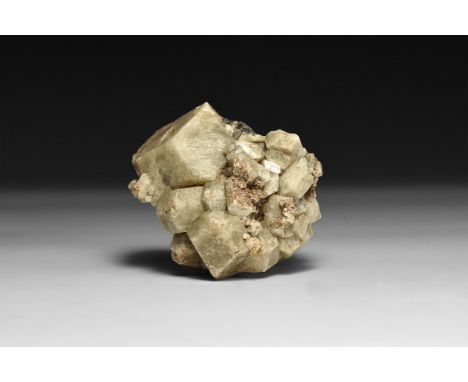 A fine large pale green garnet specimen, in white card tray with label reading: 'Grossular Garnet, Chihuahua, Mexico'.  334 g