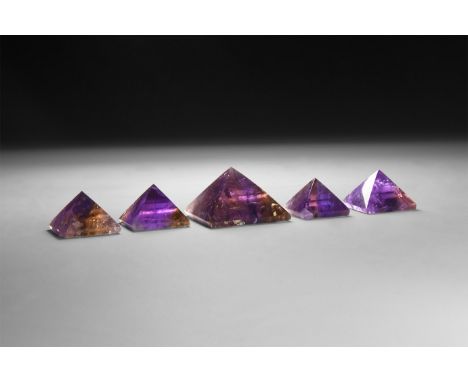 A group of five finely cut and polished ametrine pyramids.  106 grams total, 24-40mm (1 - 1 1/2"). From a historic ‘Victorian