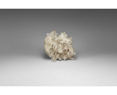 A formation of numerous translucent to transparent quartz crystals on matrix.  443 grams, 11.6cm (4 1/2"). From the historic 