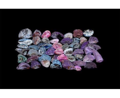 A group of one hundred cut and polished colour enhanced small geode halves from Brazil.  1 Kg total, 23-46mm (3/4 - 1 3/4"). 