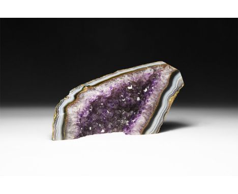 A fine purple amethyst crystals on a sheet of layered blue and white agate.  557 grams, 14.5cm (5 3/4"). From a historic ‘Vic