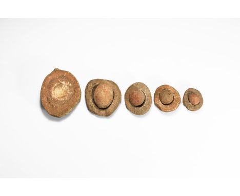 Group of five wind-rounded pebbles with their individual hollowed out 'nests', from the Kalahari Desert region, western Afric