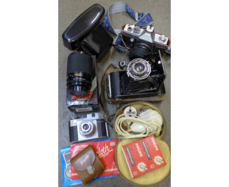 A Pentacon 35mm film camera, a Comet camera, Centon 70-120mm lens, light meter, shaver, etc.