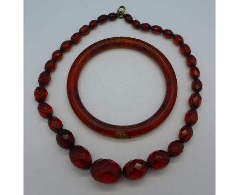 A faceted amber coloured bead necklace and a bangle