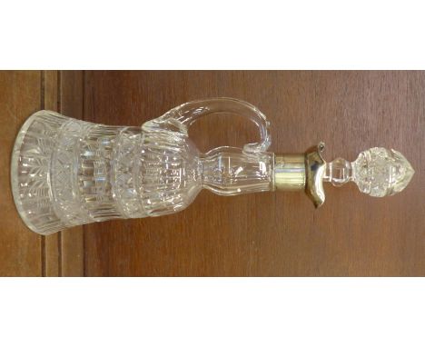 A cut glass bell shaped decanter with handle and silver rim, London 1901