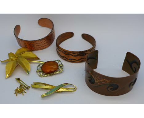 Two copper bangles and one other bangle marked Moda, hand made in Malta and four rolled gold brooches including spider
