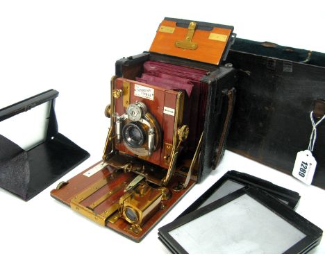 An Early XX Century Sanderson Quarter Plate Camera, Planastigmat F6.8 focus 4¾" lens, mahogany and brass construction, two pl