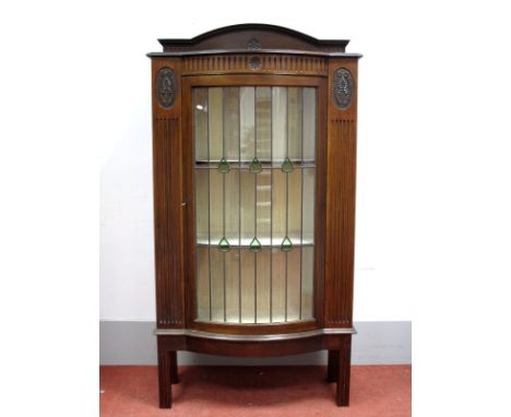 An Early XX Century Mahogany Bow Fronted Display Cabinet, with low back, leaded glazed door, reeded sides, on square reeded l