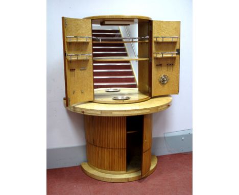 An Art Deco Satinwood Demi Lune Cocktail Cabinet, with bow fronted doors, fitted interior and glass back, the base with drink