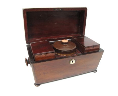 An Early XIX Century Mahogany Tea Caddy, of sarcophagus form with turned handles and raised on bun feet, opening to reveal tw