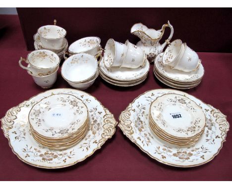 A Rockingham Porcelain Tea and Coffee Service, decorated in pattern 1512 with flowers and foliage in gilt, puce printed marks