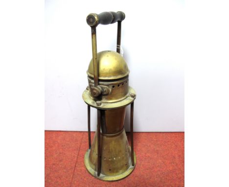 An Unusual Large Brass Miner's Safety Lamp, with tapered base and swing handle, (glass panel missing), overall height 44cm.