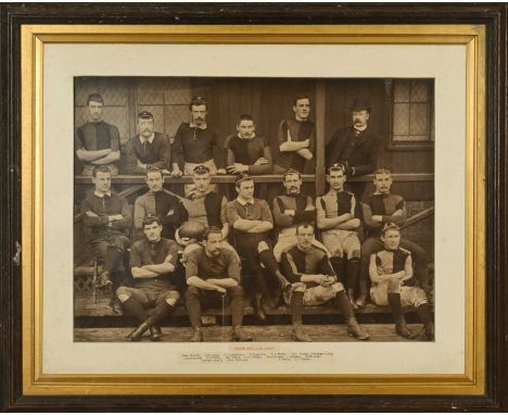 A PERIOD FRAMED BLACK & WHITE PHOTOGRAPH OF THE NEWPORT RUGBY TEAM IN 1886-87The team informally arranged outside of a pavili
