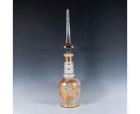 Handcrafted lidded vase featuring intricate gold gilt accents and hand painted floral motifs in high relief. Body has an eleg