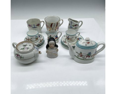 Porcelain miniature dishes include - 2 teapots, 2 teacups, 6 saucers, Nun figurine, creamer jug, 2 teacups and pitcher. Japan
