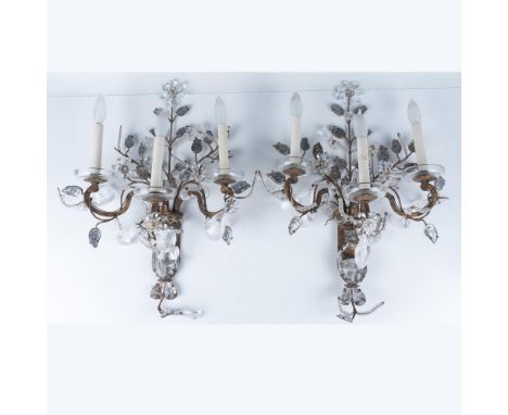 Gorgeous pair of antique gilded, cut crystal three-light sconces. Each features hand-applied ornamental flowers of different 