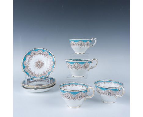 This fine bone China set is in the A16353 pattern. It is pristine white adorned with blue borders, gilt trim, and intricate b