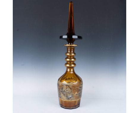 Impressive hand blown amber glass vessel featuring an intricately detailed stopper with a sharp, elongated obelisk finial. Th