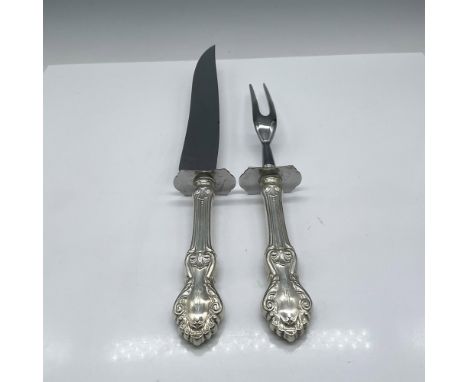 Elegant design of scrolls with vines on sterling handles. Set includes carving knife with stainless steel blade 14" and fork 