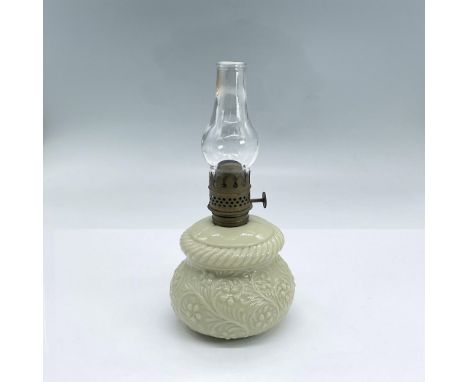 Small oil lamp with clear glass chimney and cream milk glass body decorated with flower and leaf design. Dimensions: 7.75"H x