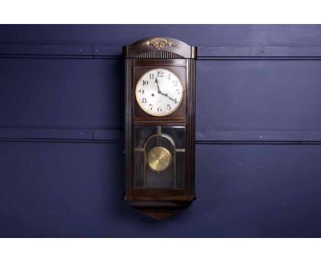 EARLY TWENTIETH CENTURY ART DECO MAHOGANY WALL CLOCK
by Gustav Becker, the signed two train movement striking on a gong, the 