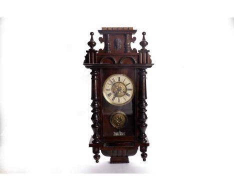 LATE NINETEENTH CENTURY MAHOGANY VIENNA STYLE WALL CLOCK
unsigned two train movement, the 7 inch gilt enamel dial with Roman 