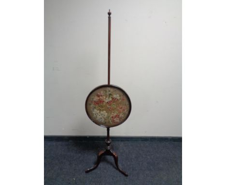 A 19th century mahogany tapestry pole screen. 