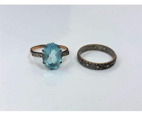 A 9ct gold and silver dress ring set with a blue stone, together with a 9ct and silver band ring. (2)